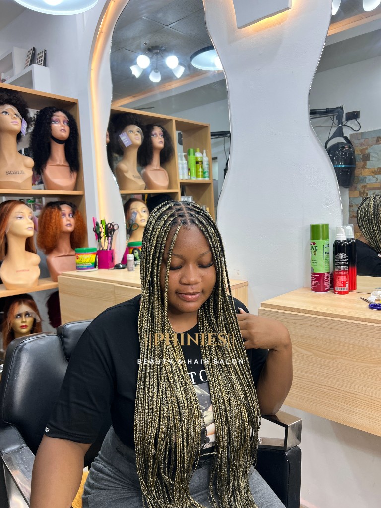 Client with long box braids in the salon