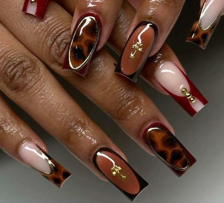 Burgundy and tortoiseshell nail art with gold accents